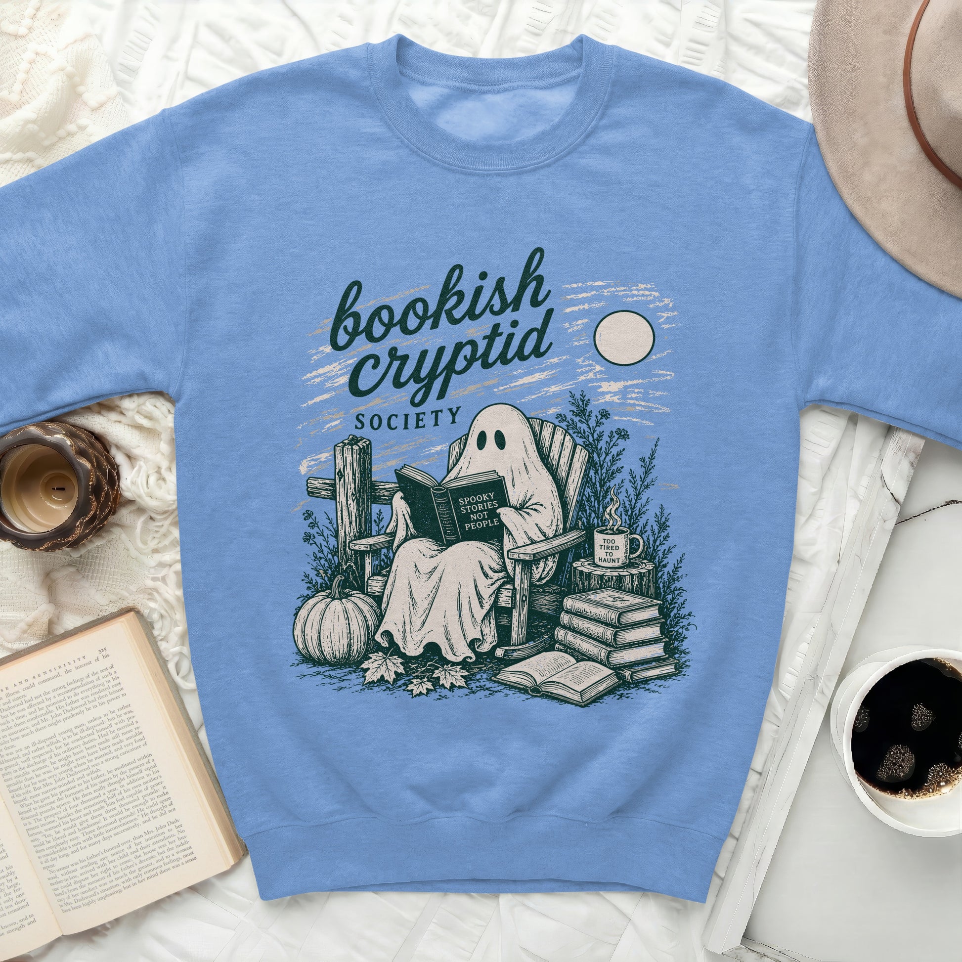 Ghost reading a book with "Spooky Stories Not People" text on a sweatshirt.