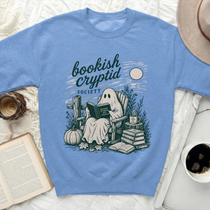 Ghost reading a book with "Spooky Stories Not People" text on a sweatshirt.