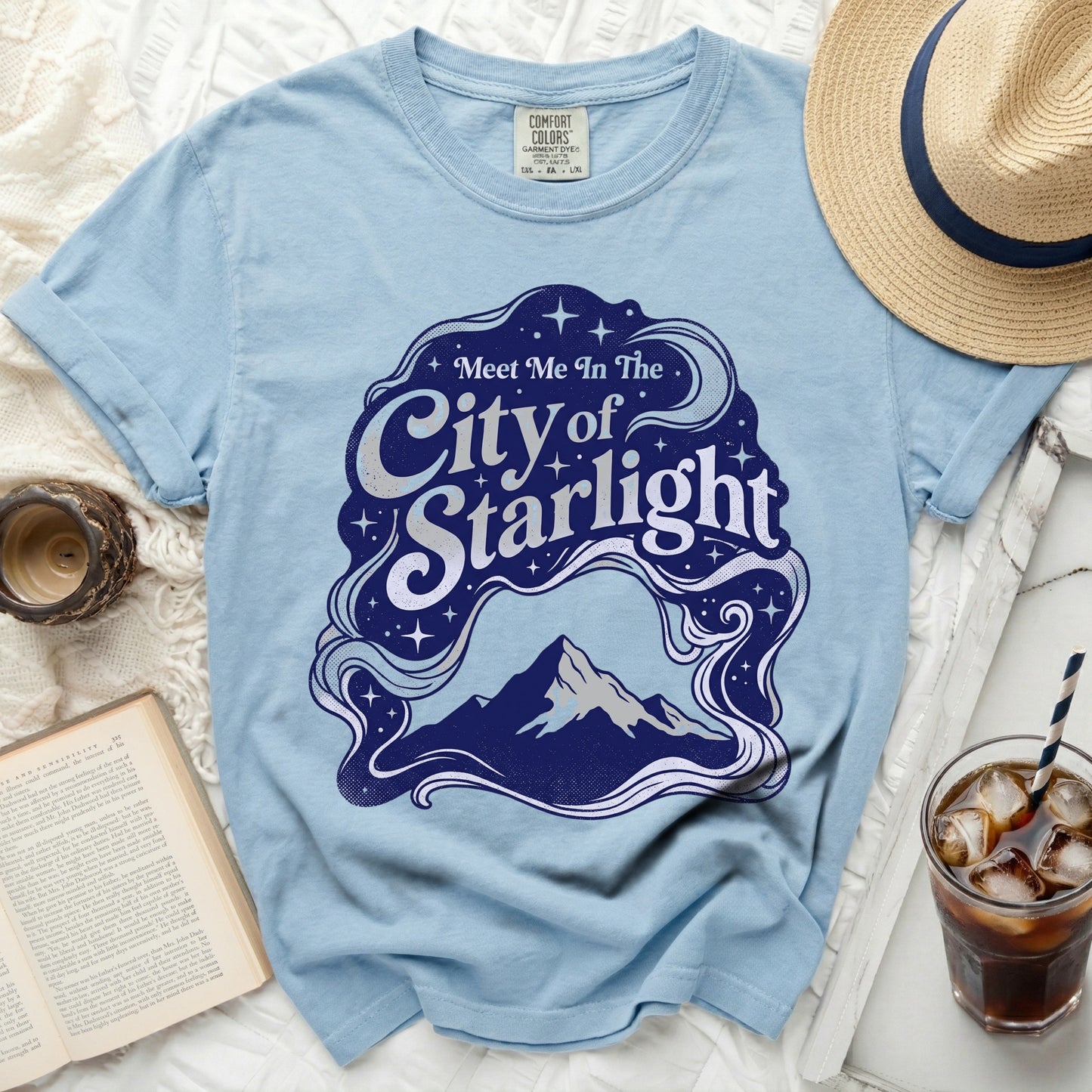 Light blue t-shirt with "Meet Me In The City of Starlight" graphic.