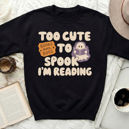Black sweatshirt with "Too Cute To Spook I'm Reading" text and ghost.