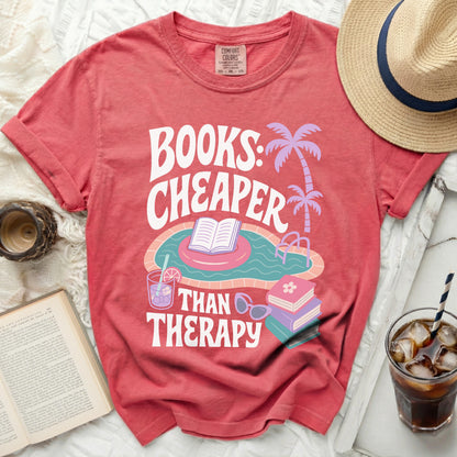 Coral t-shirt with "Books: Cheaper Than Therapy" text and pool graphic.