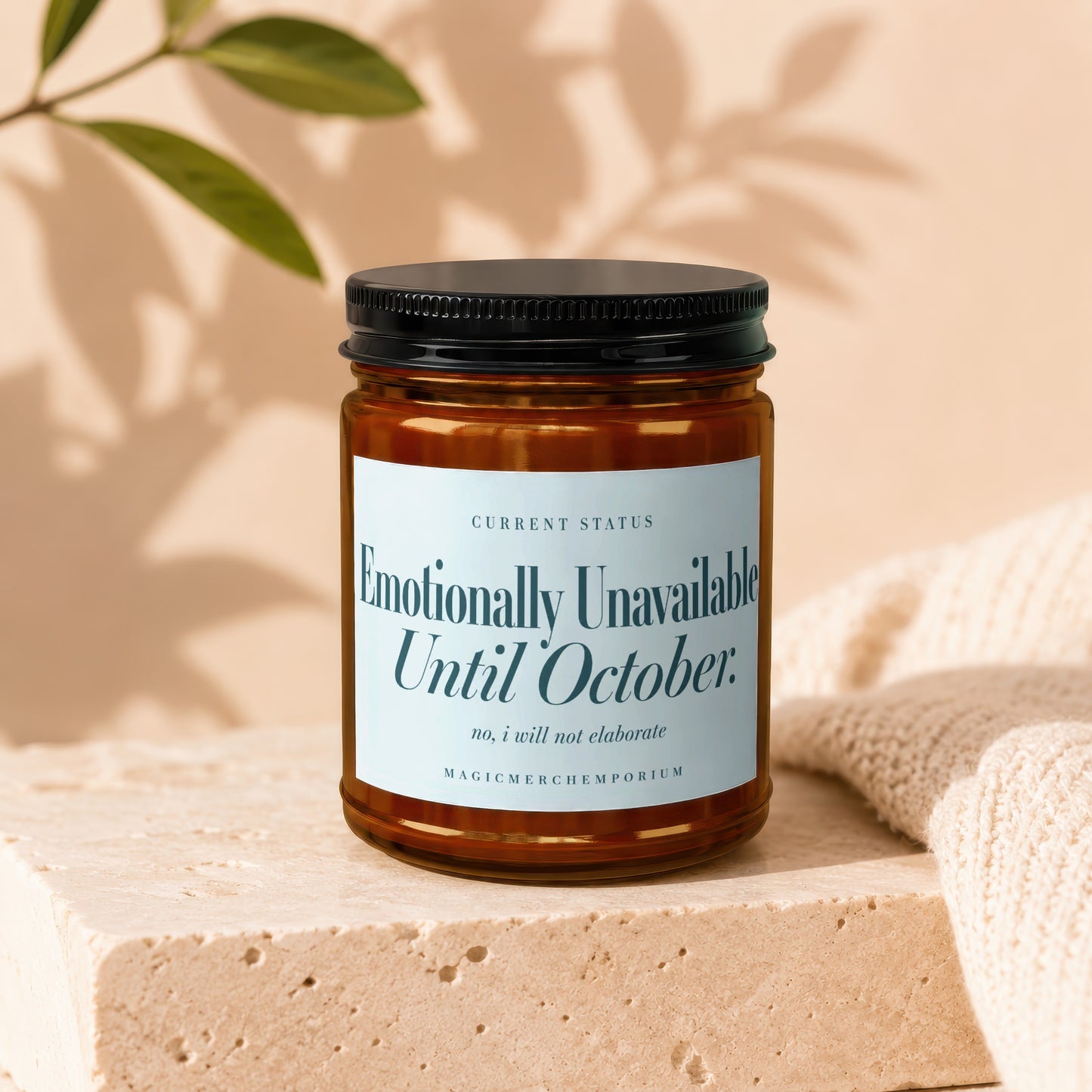 Amber candle jar with "Emotionally Unavailable Until October" label.