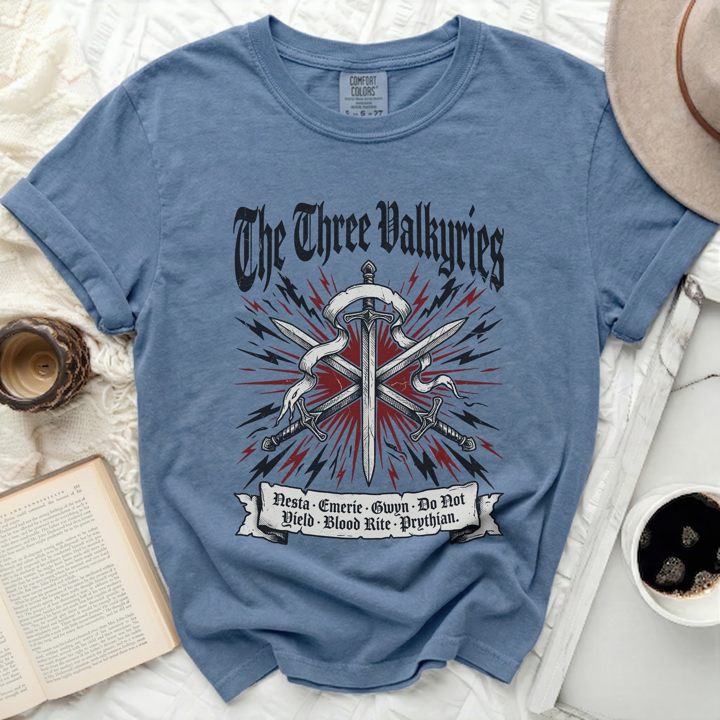 Blue t-shirt with "The Three Valkyries" text and swords graphic.
