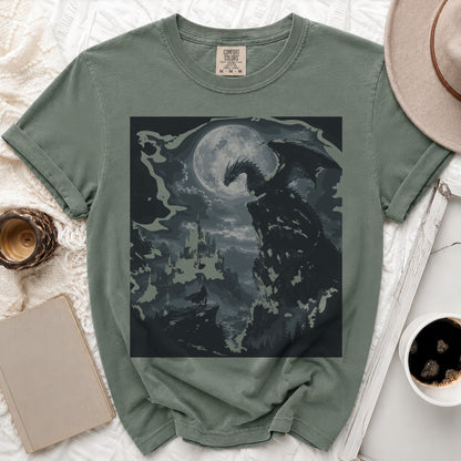 Green t-shirt with a dark dragon and castle graphic under a moon.