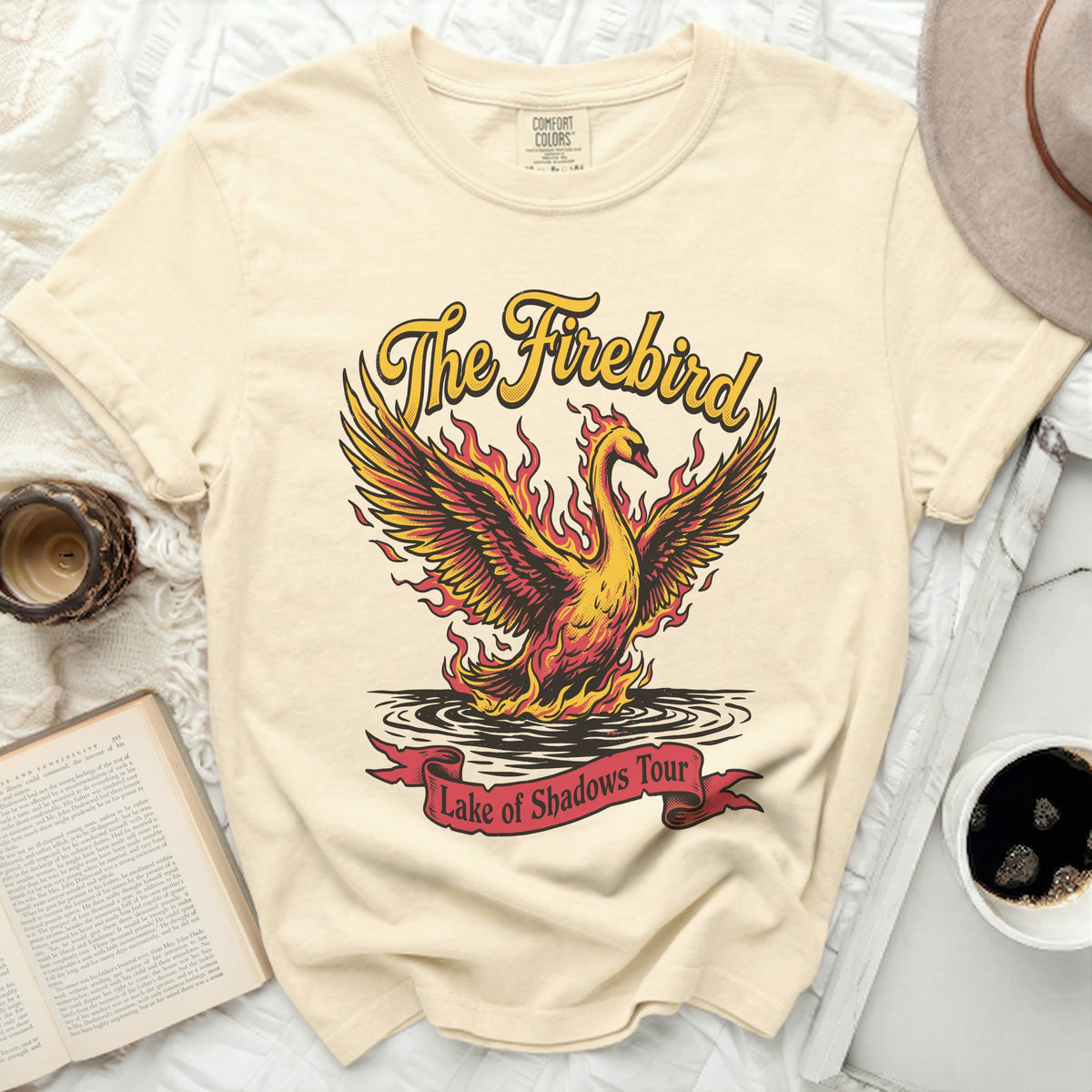 Cream t-shirt with "The Firebird" text and a fiery bird over water.