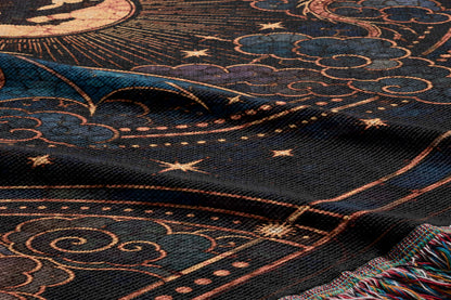 a close-up view of a detailed and intricate pattern on a fabric, with a mix of dark and light colors, including shades of blue, black, and gold. The pattern appears to be a design with stars, clouds, and other celestial elements, creating a sense of depth and complexity. The fabric itself has a textured appearance, adding to the overall visual interest of the image.