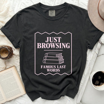 Dark grey t-shirt with "JUST BROWSING FAMOUS LAST WORDS" text and stacked books graphic.