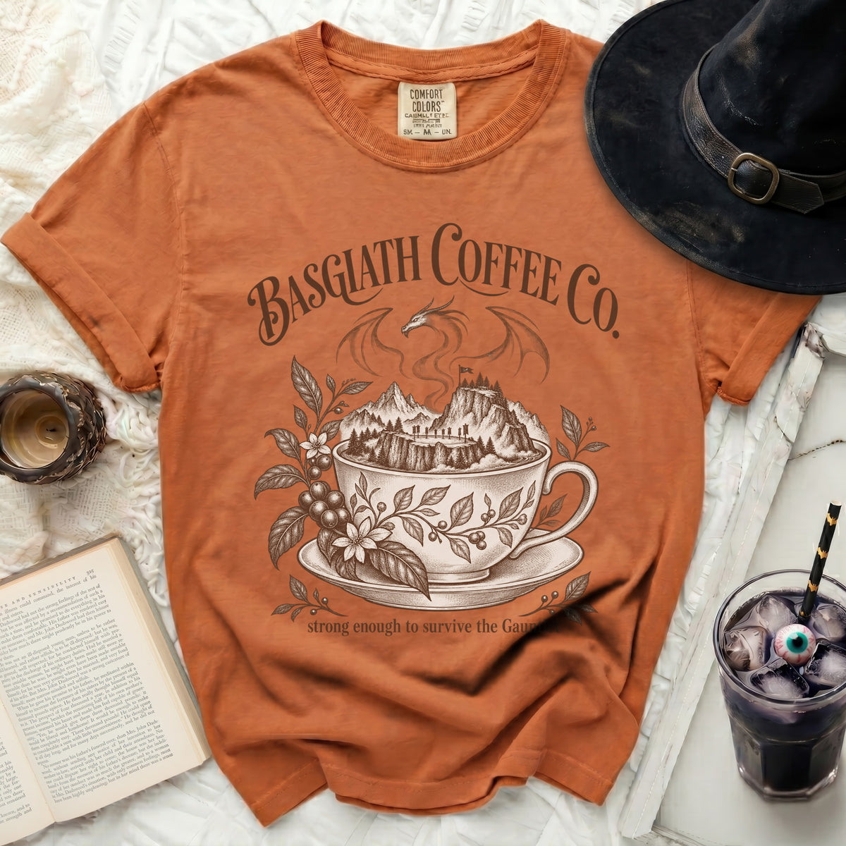 Orange t-shirt with "Basgiath Coffee Co. strong enough to survive the Gaunt" graphic.