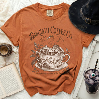 Orange t-shirt with "Basgiath Coffee Co. strong enough to survive the Gaunt" graphic.