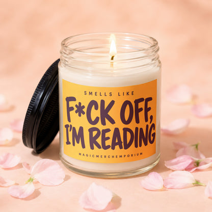 Jar candle with lit flame and label reading "Smells like F*ck off, I'm reading".