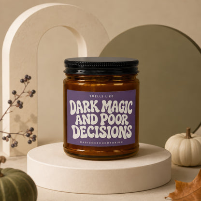 Amber glass candle with black lid, labeled "Smells Like Dark Magic And Poor Decisions".
