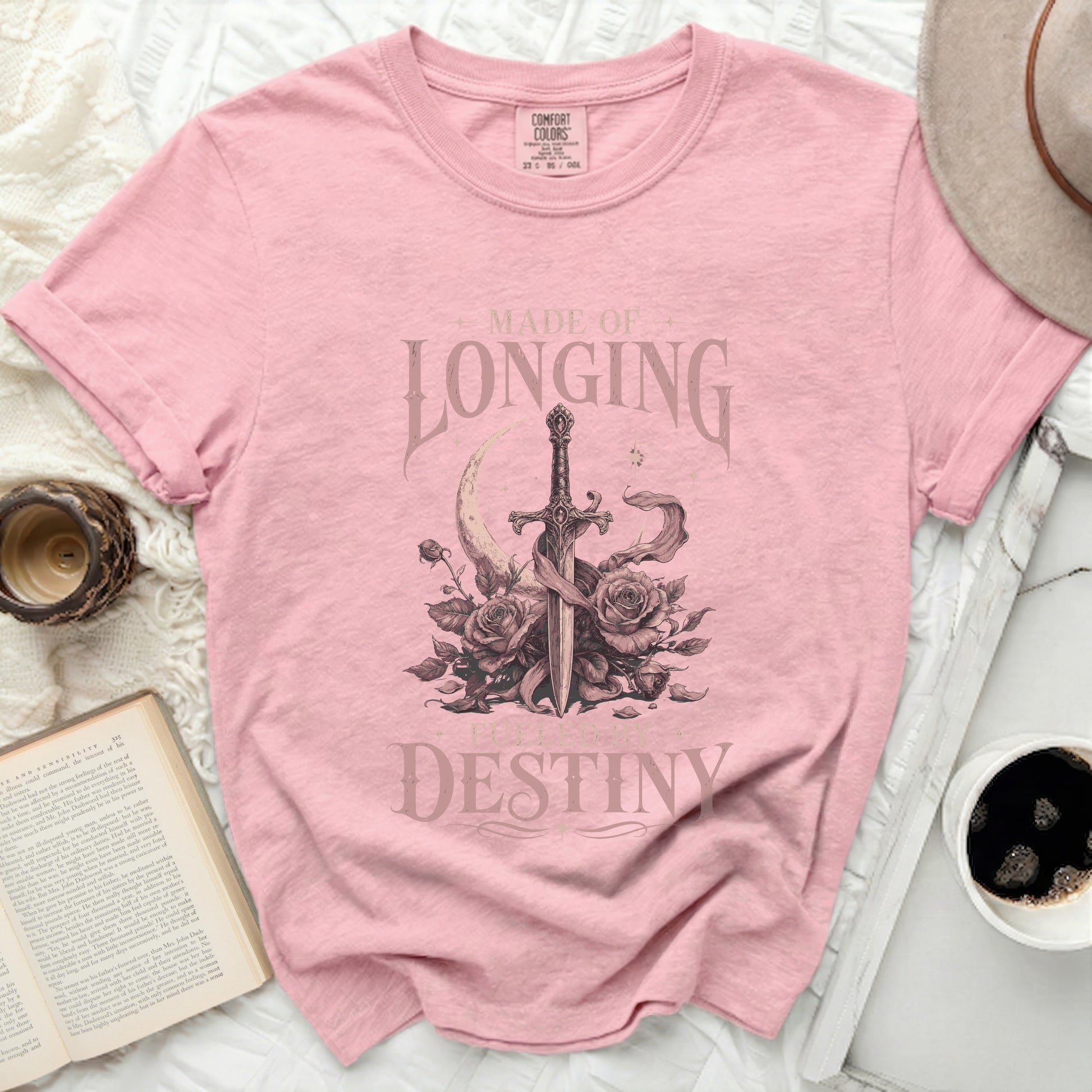 Pink t-shirt with sword, roses, moon, and text "MADE OF LONGING FUELED BY DESTINY".
