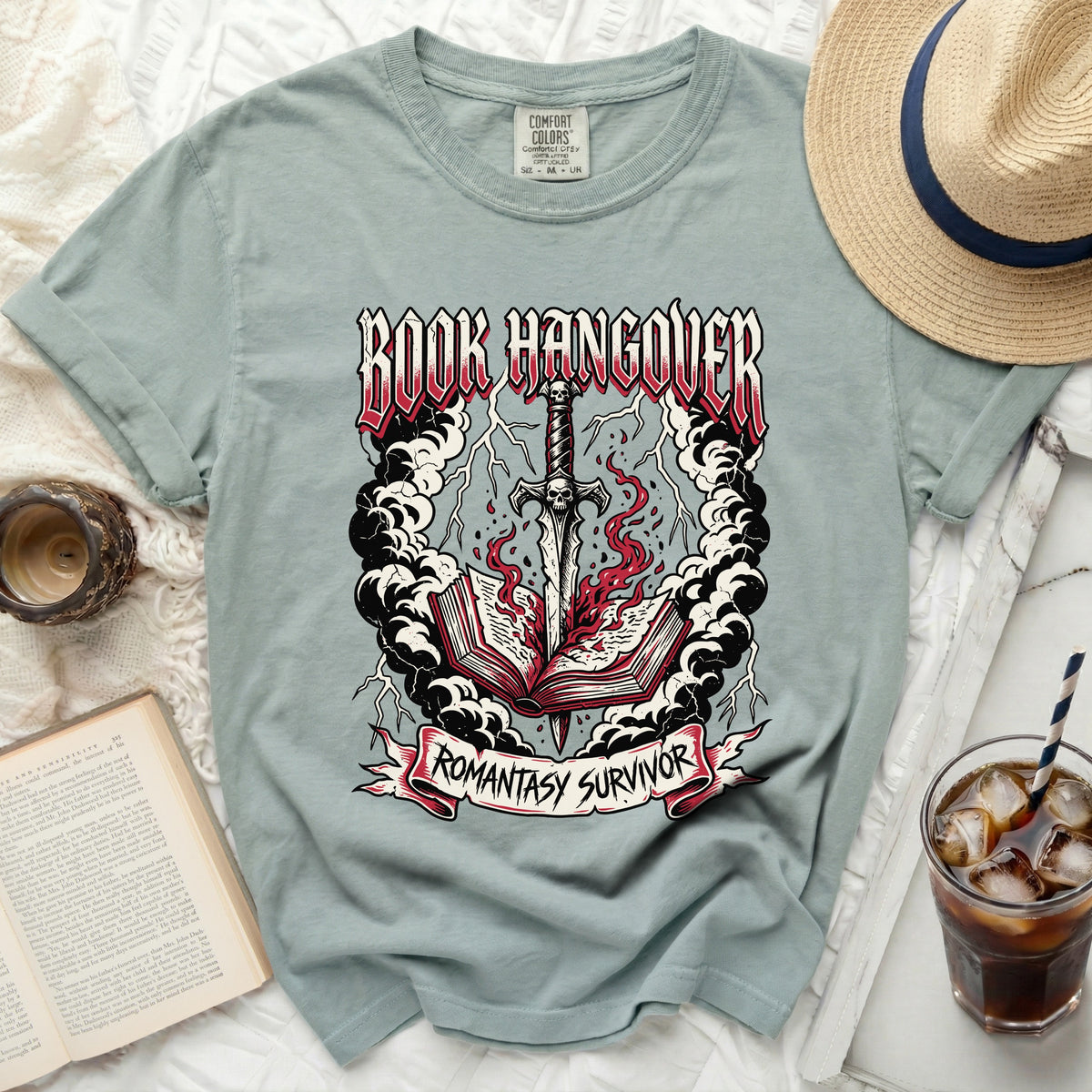 Green t-shirt with "BOOK HANGOVER" and "ROMANTASY SURVIVOR" text and sword graphic.