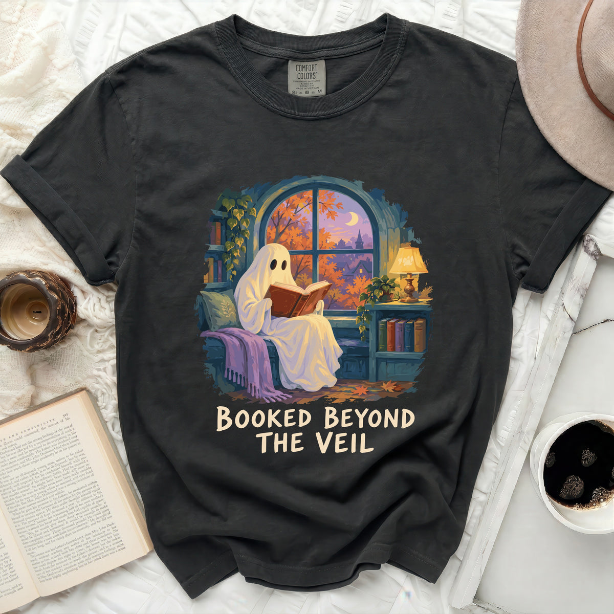 Dark t-shirt with "Booked Beyond The Veil" text and ghost reading a book.