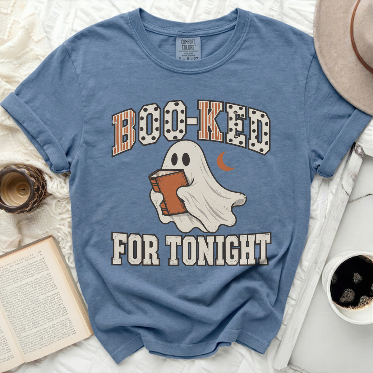 Ghost reading book with text "BOO-KED FOR TONIGHT"
