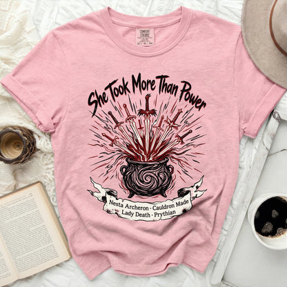 Pink t-shirt with "She Took More Than Power" and swords in cauldron design.