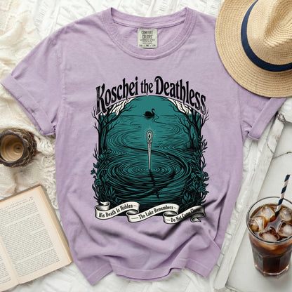 Purple t-shirt with "Koschei the Deathless" and lake scene graphic.