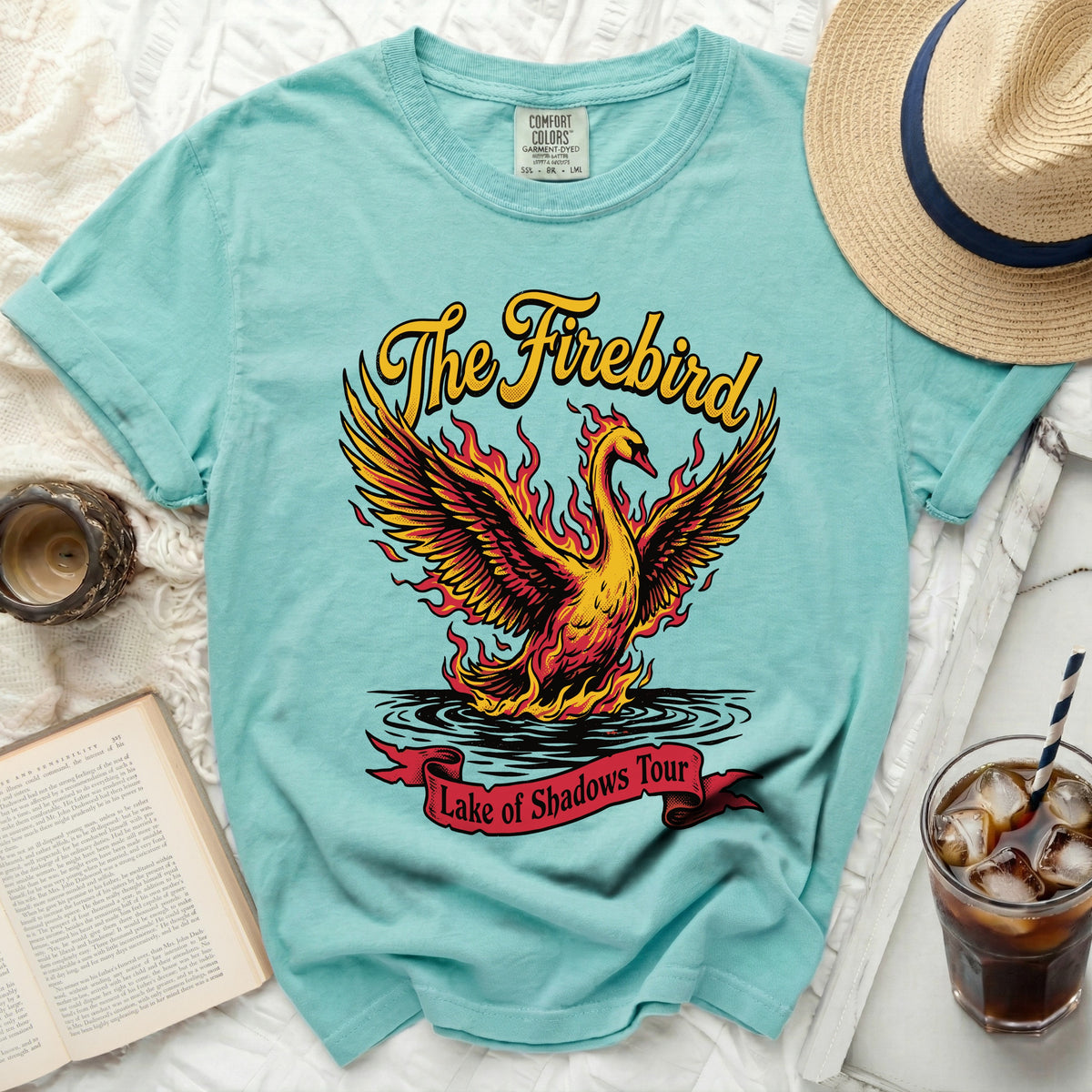 Teal t-shirt with a flame bird and "The Firebird Lake of Shadows Tour" text.