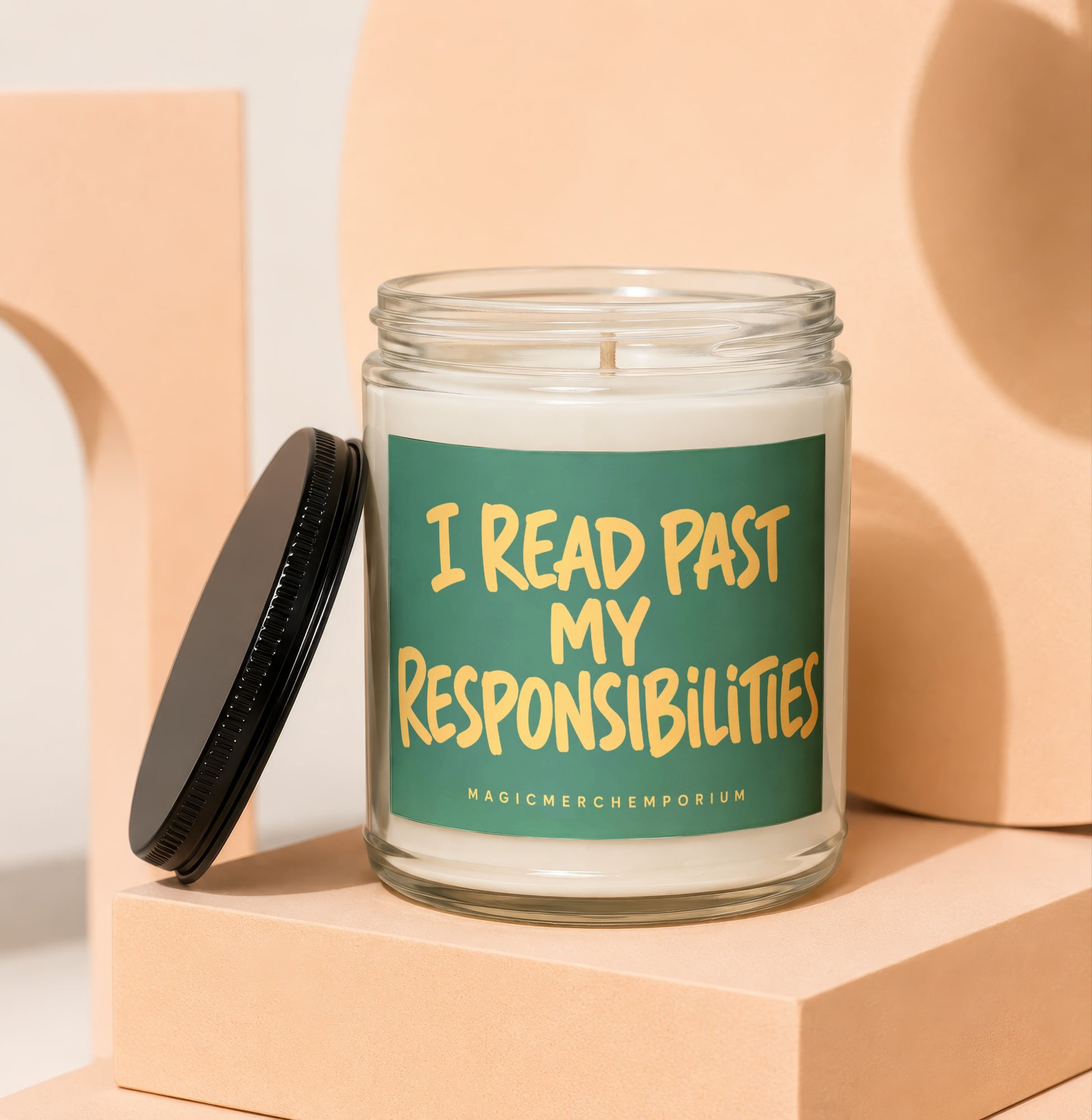 Glass candle with green label that reads "I READ PAST MY RESPONSIBILITIES"
