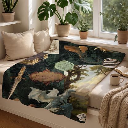 A blanket with dragons, a sword, a book, and text "The spell could be broken only by love."