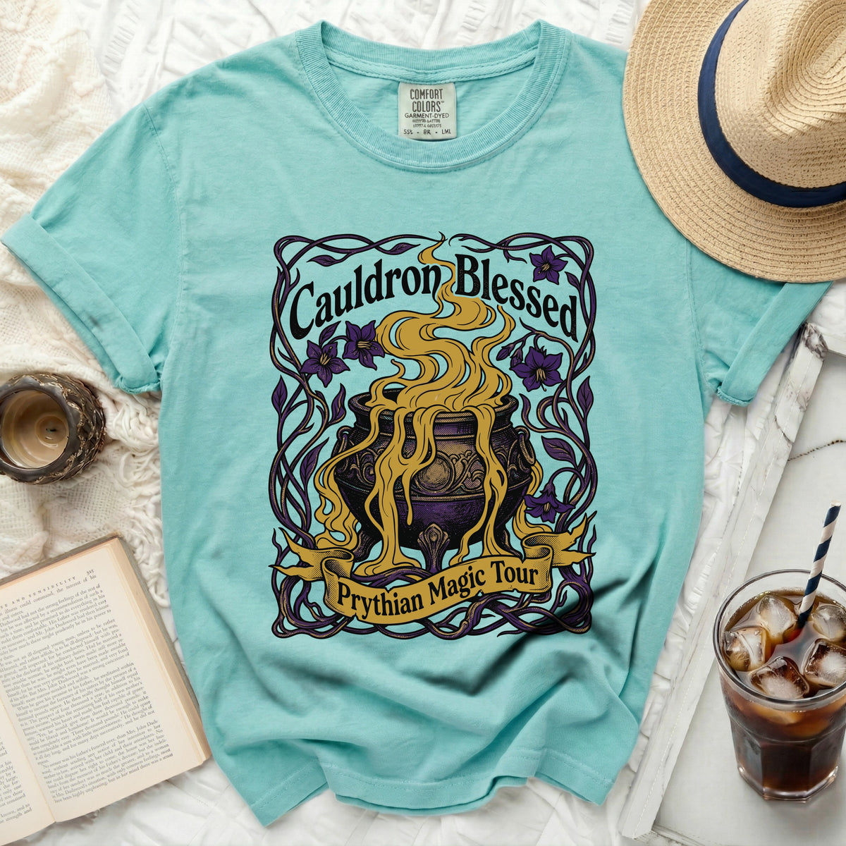 Aqua t-shirt with a "Cauldron Blessed Prythian Magic Tour" graphic.