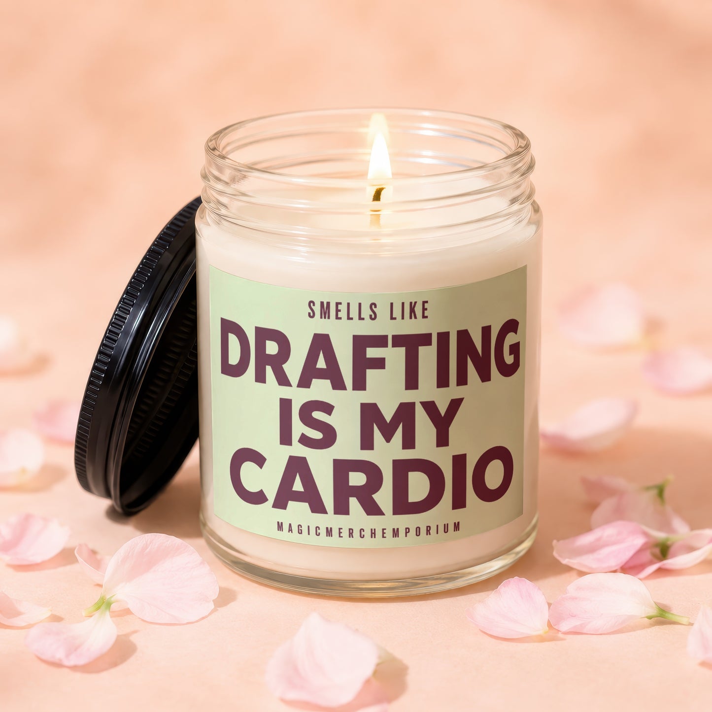 Glass candle with label "Smells like Drafting is my Cardio" surrounded by petals.