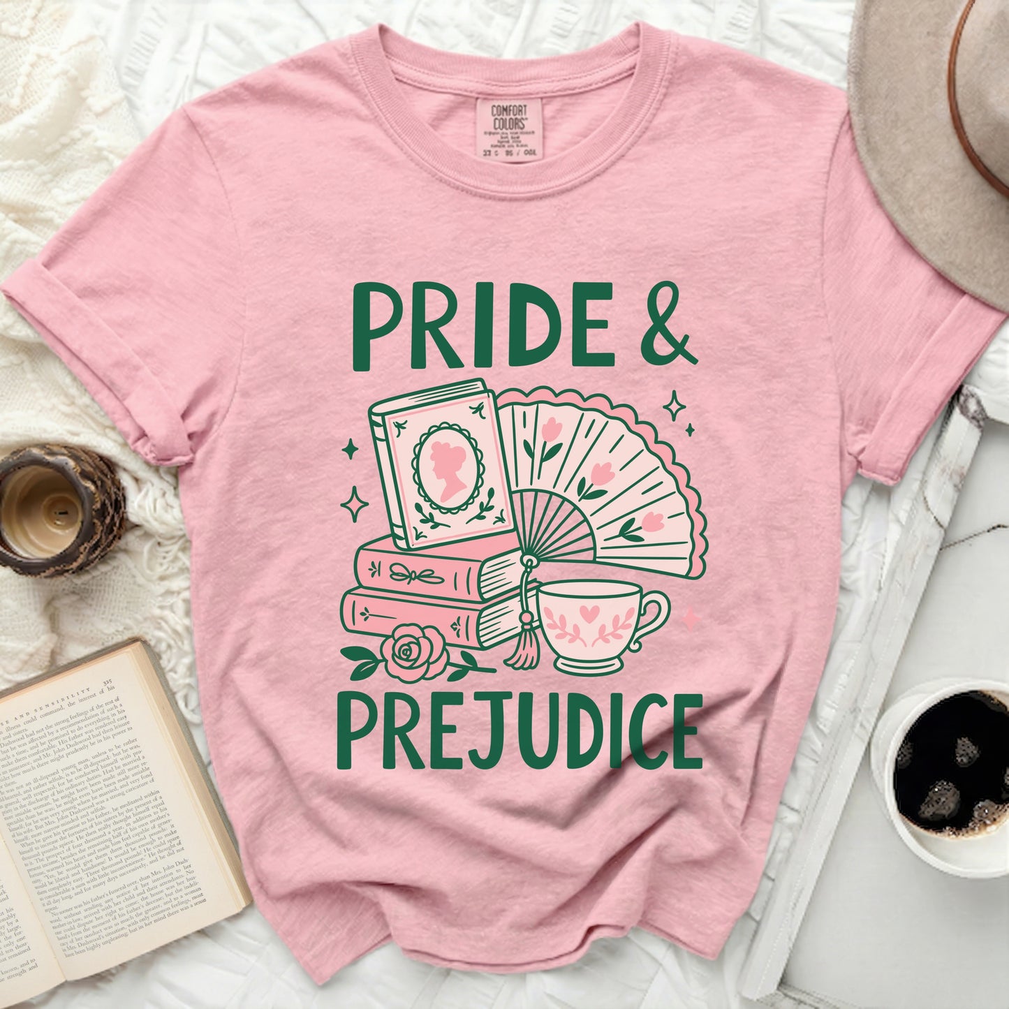 Pink t-shirt with "Pride & Prejudice" text and literary graphics.