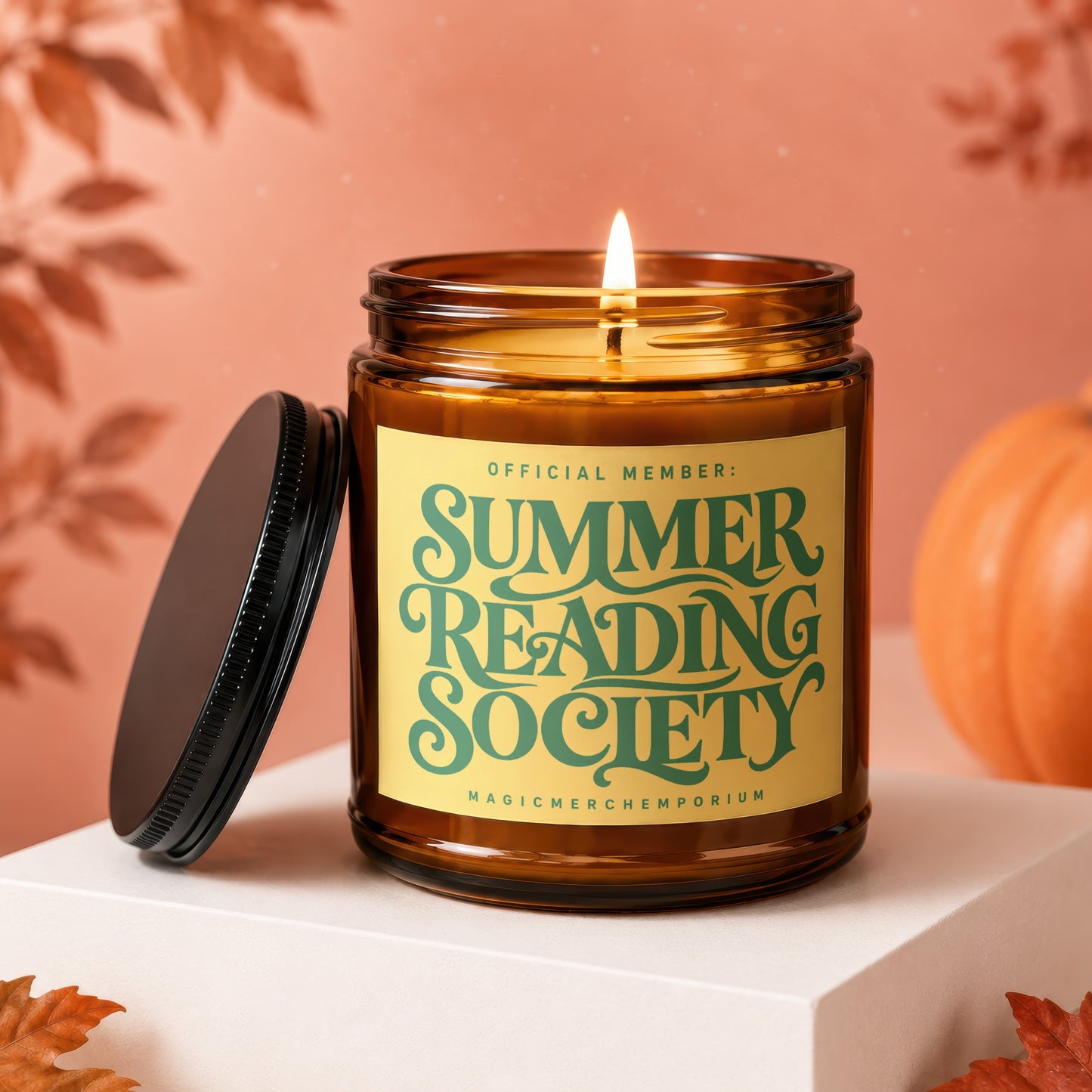 Amber jar candle with lit flame and "Summer Reading Society" label.