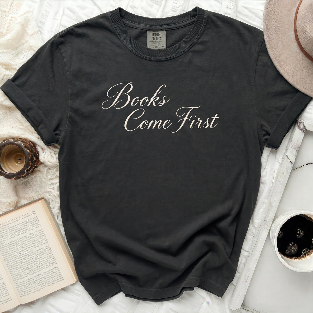 Dark gray t-shirt with "Books Come First" in cursive.