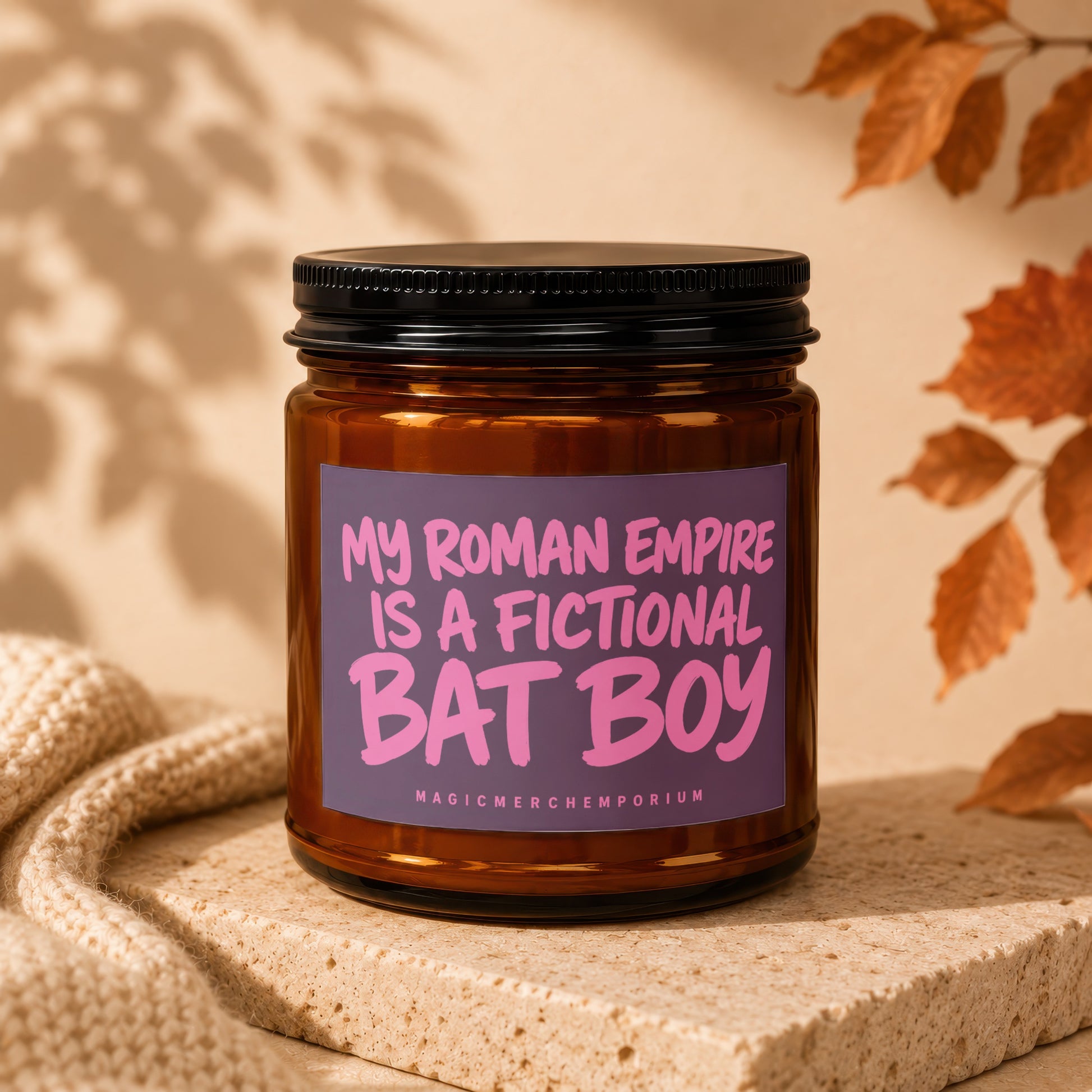 Brown glass candle with purple label reading "My Roman Empire is a Fictional Bat Boy".