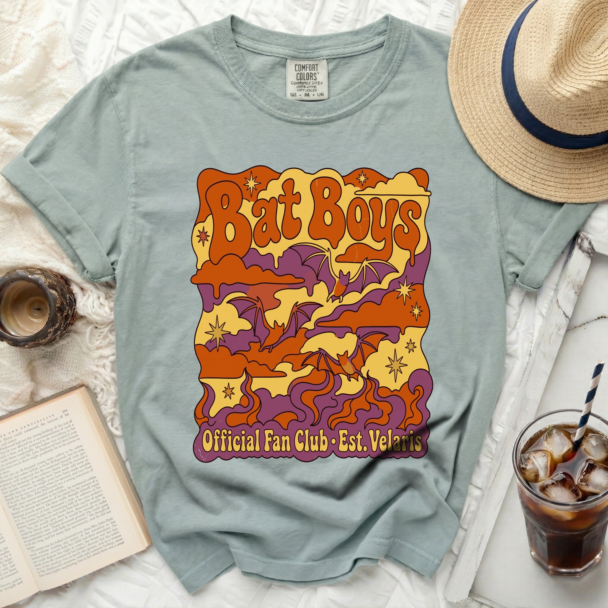 Green t-shirt with "Bat Boys Official Fan Club Est. Velaris" graphic.