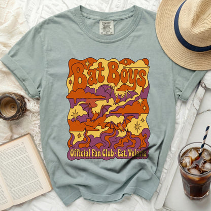 Green t-shirt with "Bat Boys Official Fan Club Est. Velaris" graphic.