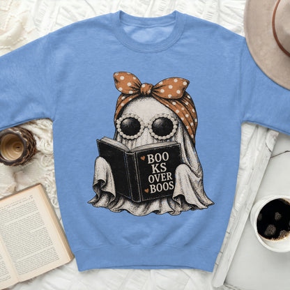 Ghost reading a book with text "Boo ks Over Boos" on a blue sweatshirt.