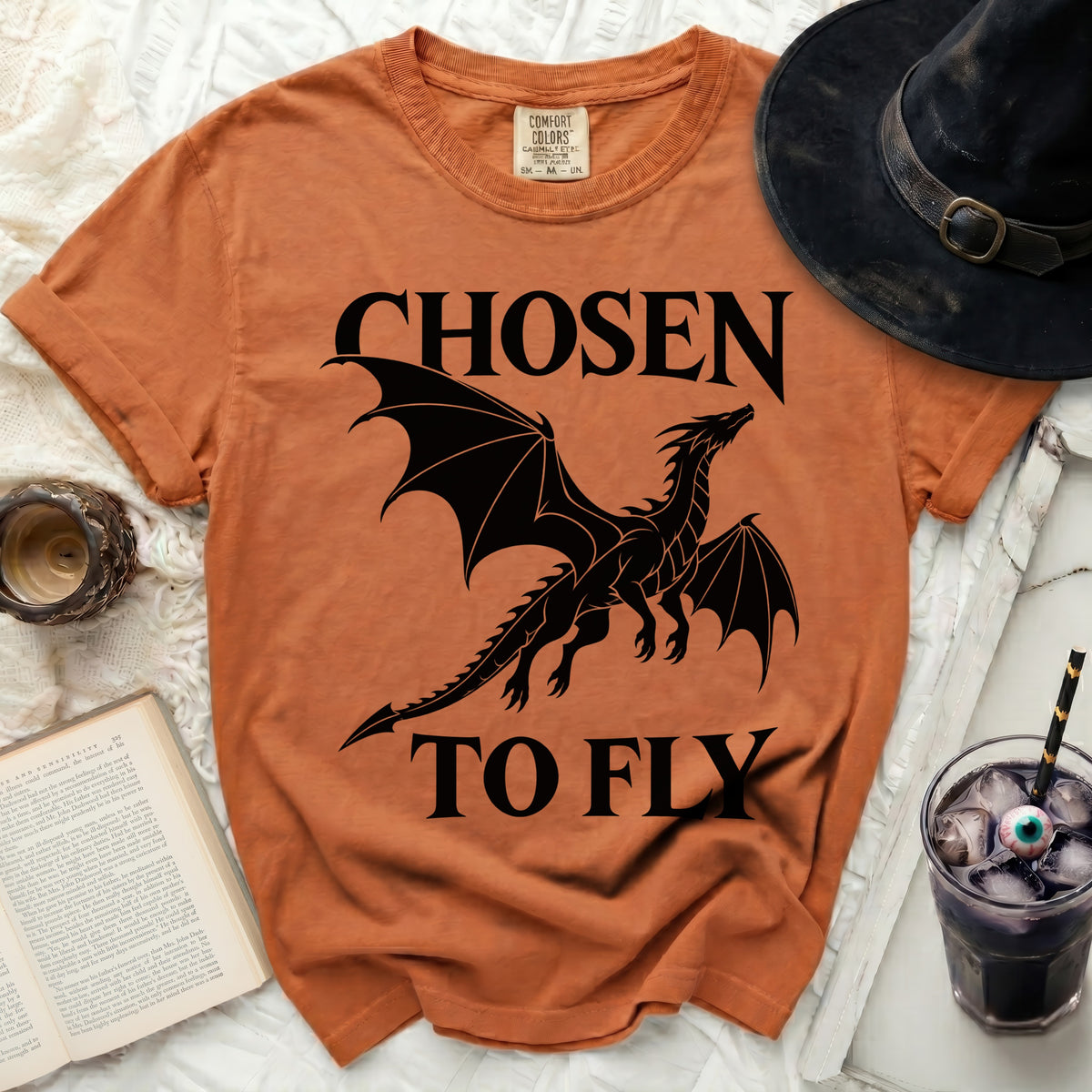 Orange t-shirt with black dragon graphic and text "CHOSEN TO FLY".