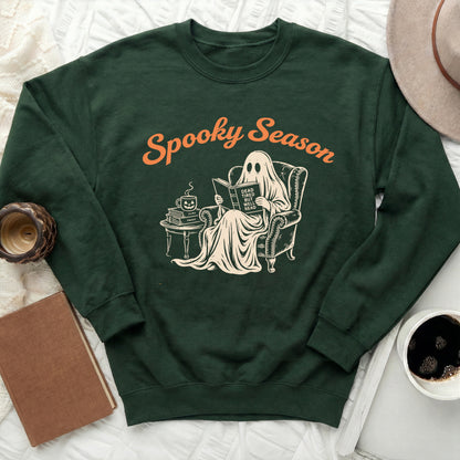 Green sweatshirt with "Spooky Season" text and a ghost reading a book.