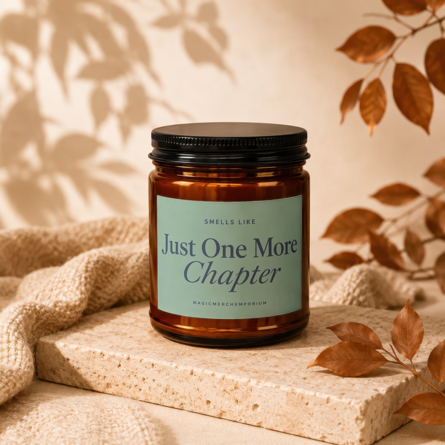 Candle with black lid, reading "Smells Like Just One More Chapter".