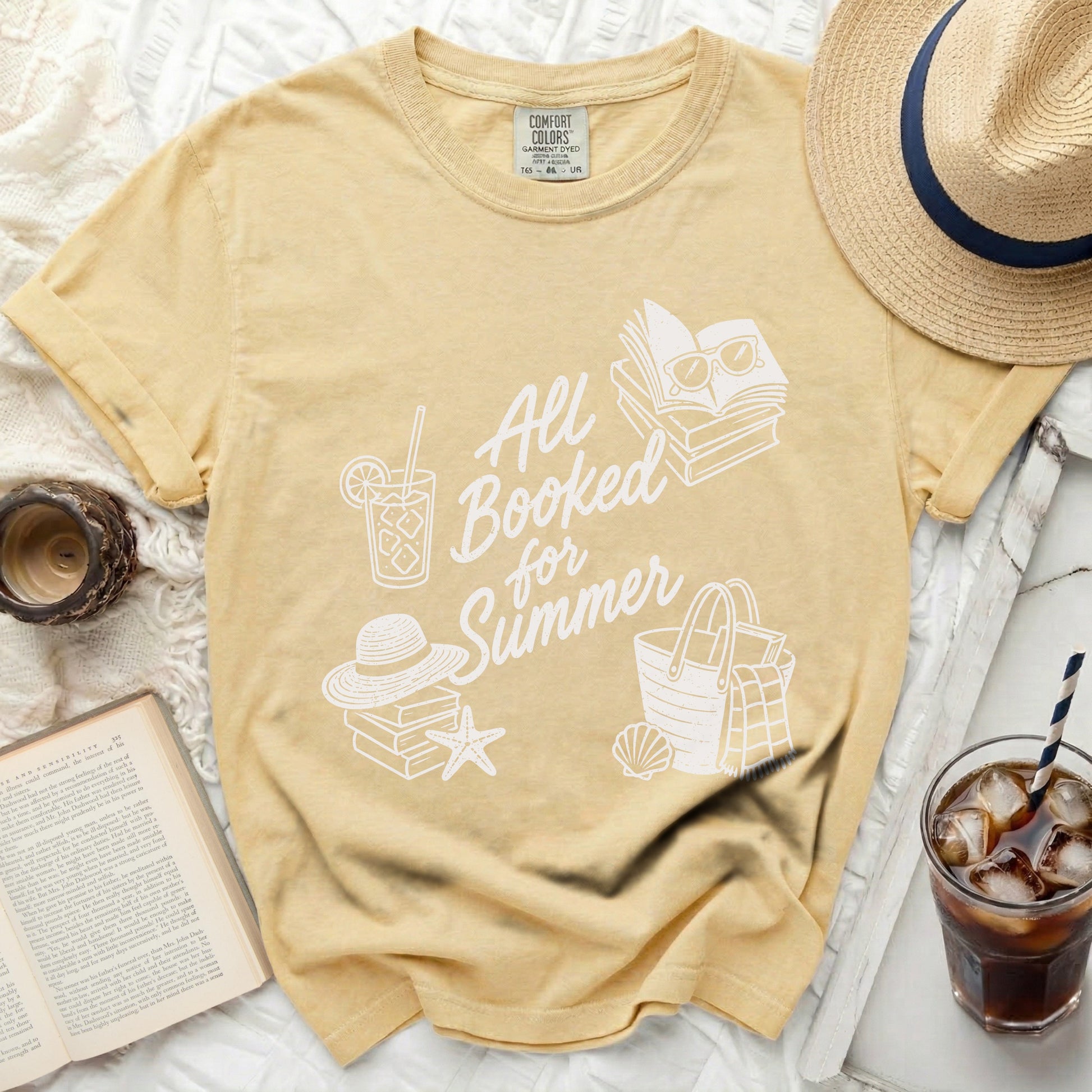 Yellow t-shirt with "All Booked for Summer" text, books, and beach icons.