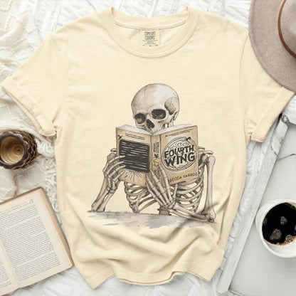 Skeleton reading a book titled "Fourth Wing" by Rebecca Yarros.
