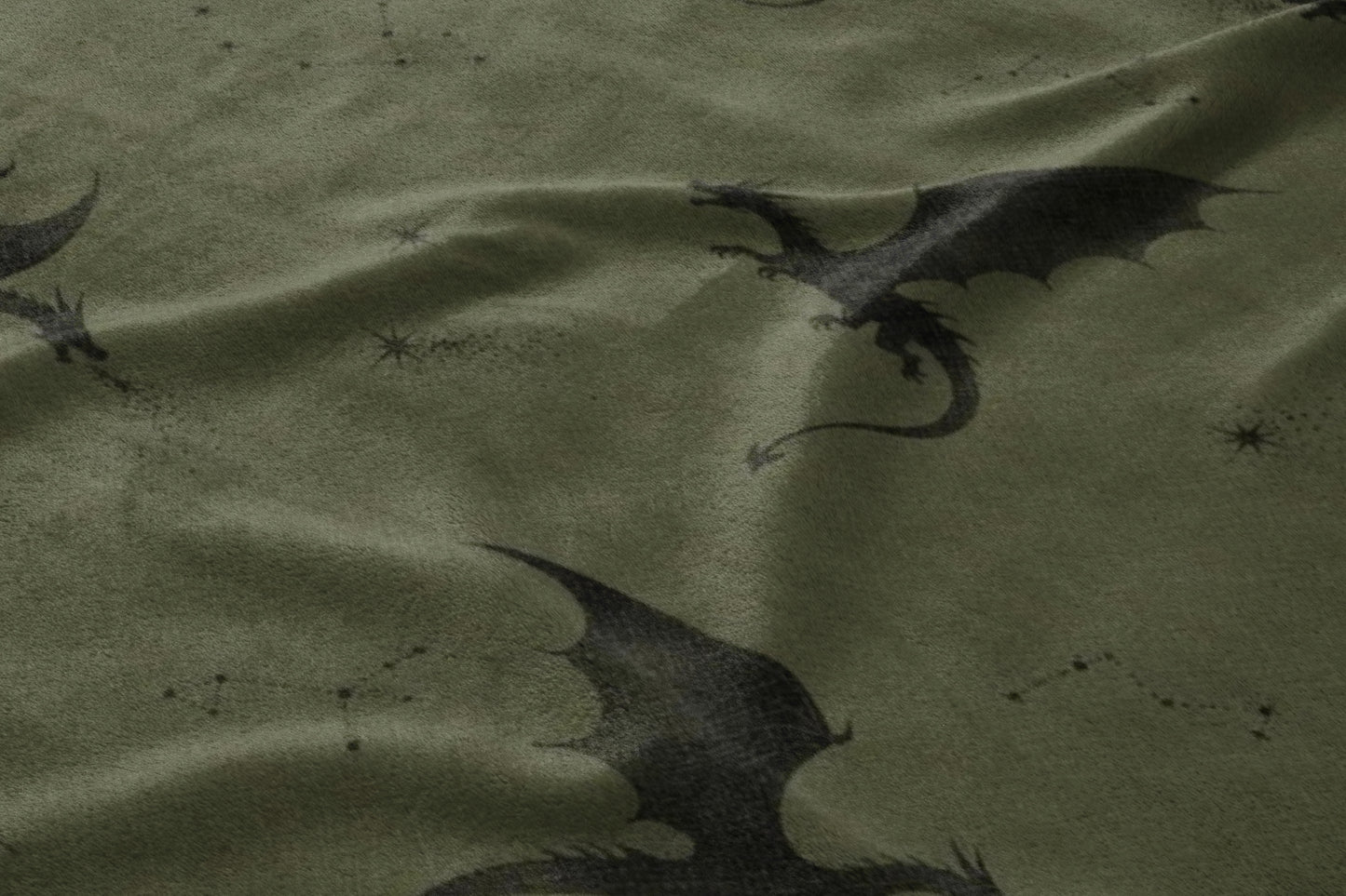 Dark green fabric with a pattern of black dragons and scattered constellations.