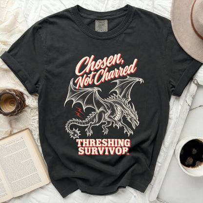 Black t-shirt with a dragon graphic and text "Chosen, Not Charred Threshing Survivor".
