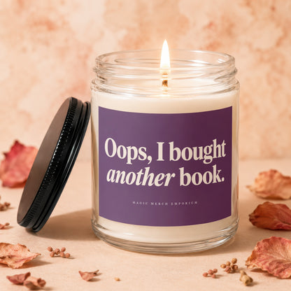 Lit candle in glass jar with text "Oops, I bought another book."