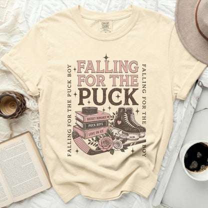 Cream t-shirt with "Falling for the Puck Boy" hockey romance graphic.