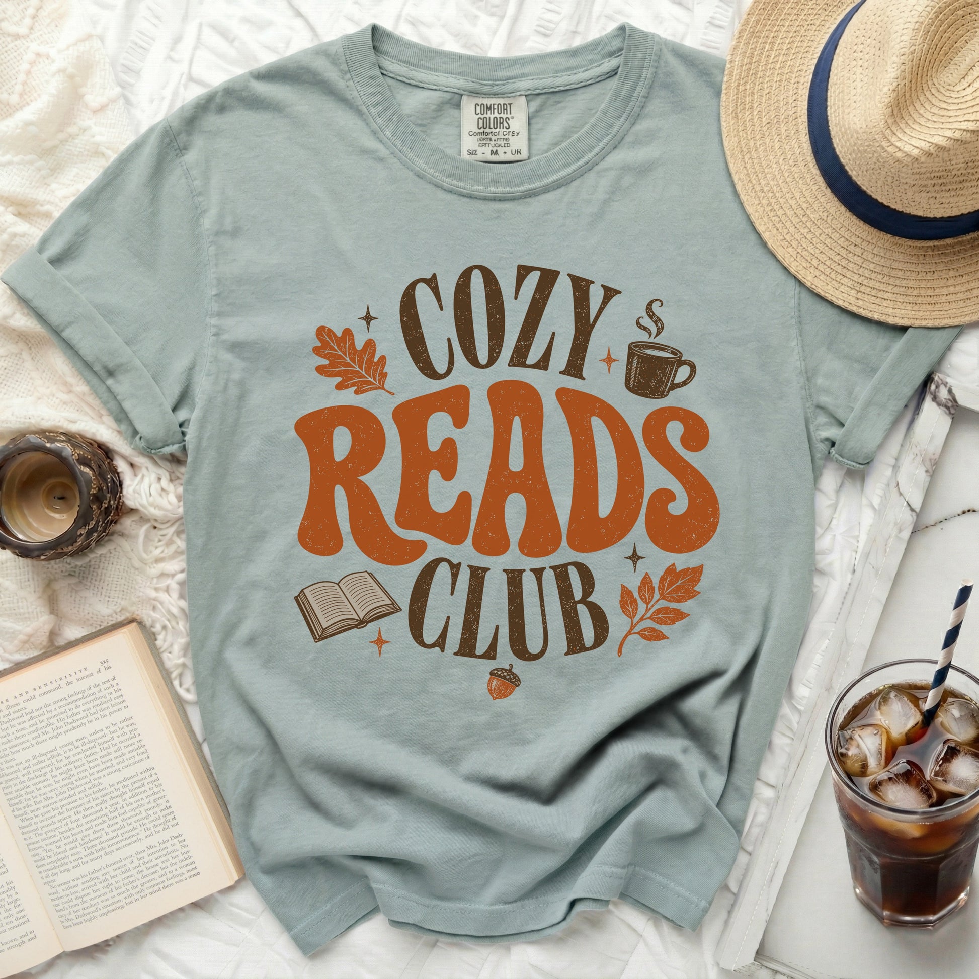 Light blue t-shirt with "Cozy Reads Club" graphic and fall motifs.