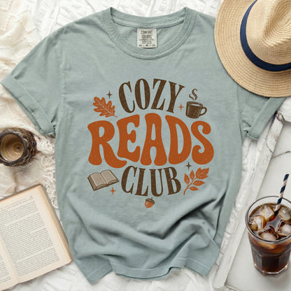 Light blue t-shirt with "Cozy Reads Club" graphic and fall motifs.