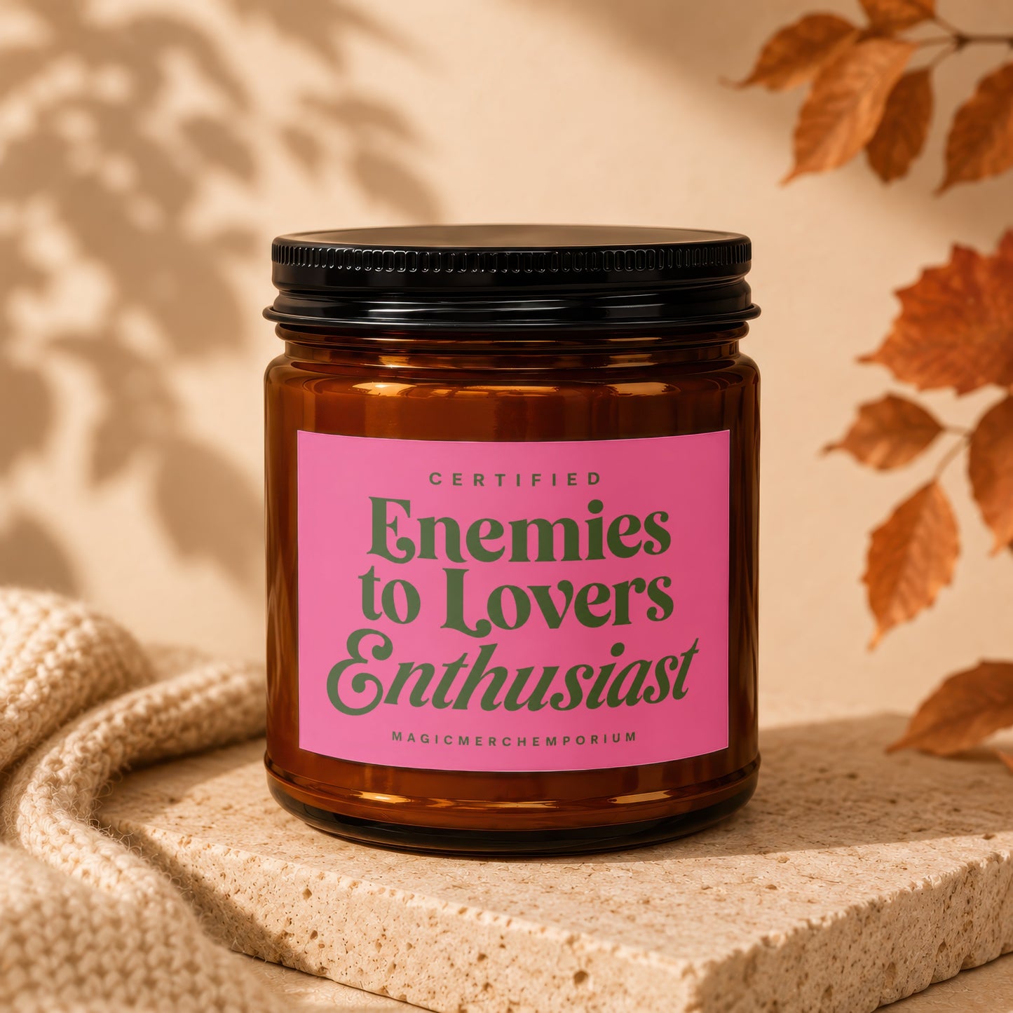 Candle with pink label reading "Certified Enemies to Lovers Enthusiast" by MagicMerchemporium.