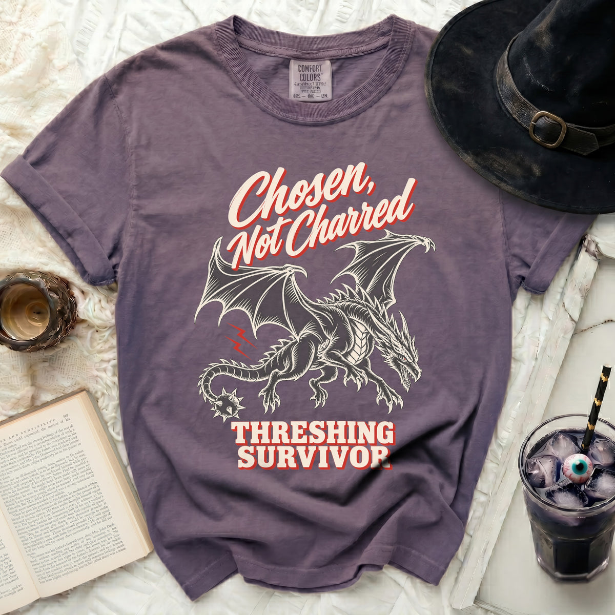 Purple t-shirt with a dragon graphic and text "Chosen, Not Charred Threshing Survivor".