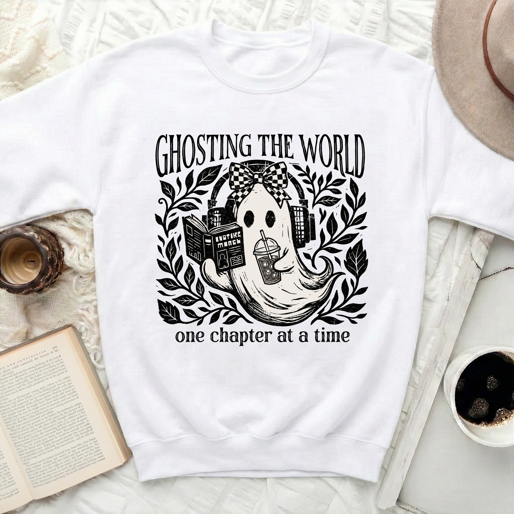 Ghosting the world, one chapter at a time graphic on a white sweatshirt.