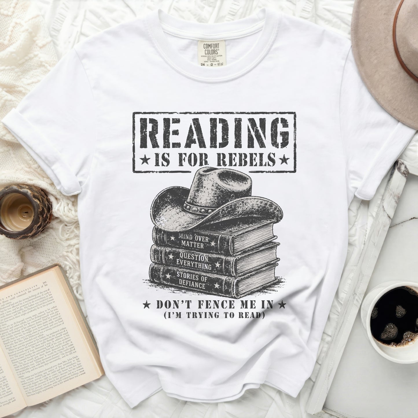 White t-shirt with "Reading is for Rebels" over stacked books graphic.