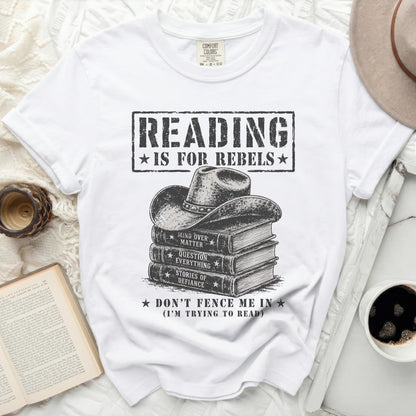 White t-shirt with "Reading is for Rebels" over stacked books graphic.