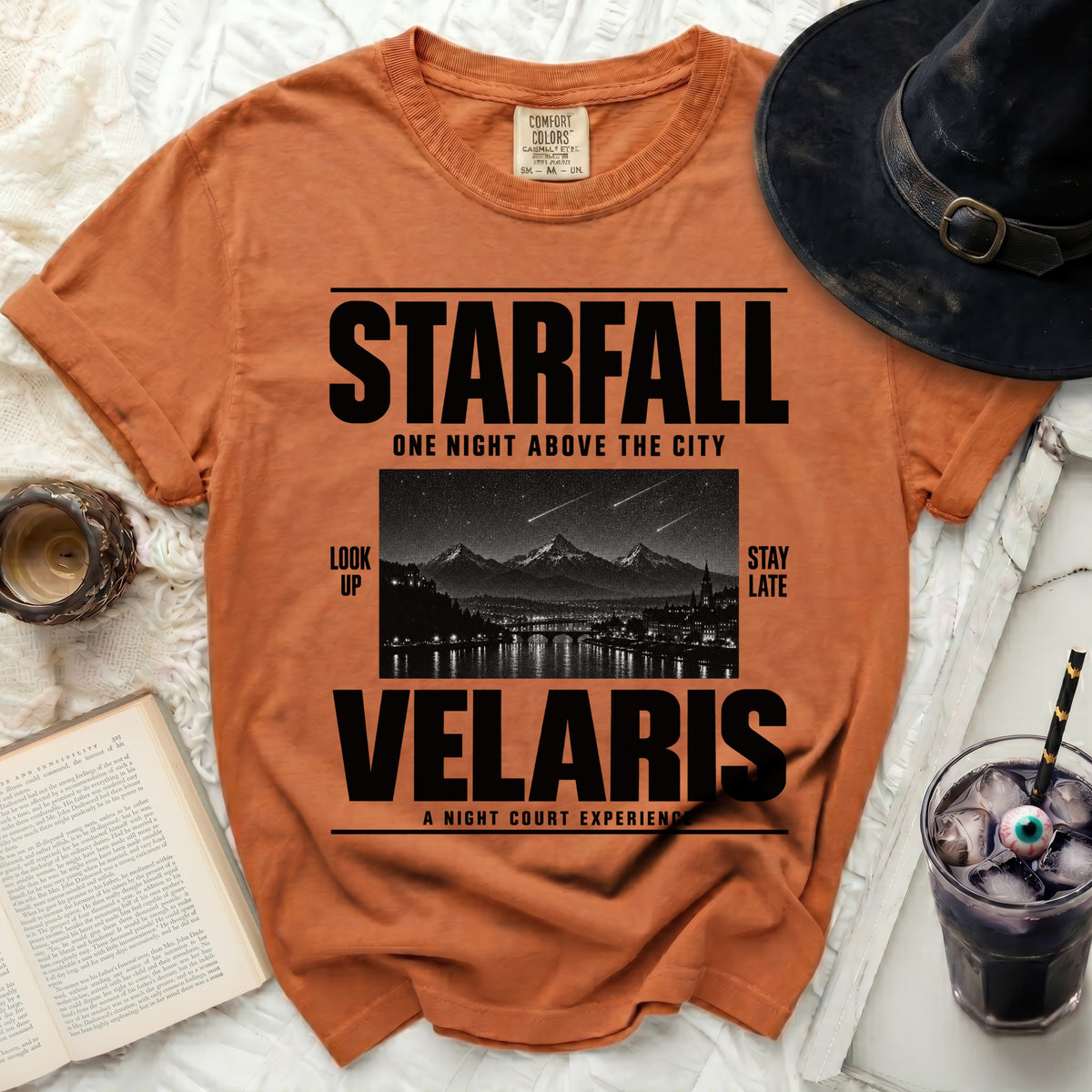 Orange t-shirt with "STARFALL VELARIS" text and starry city graphic.